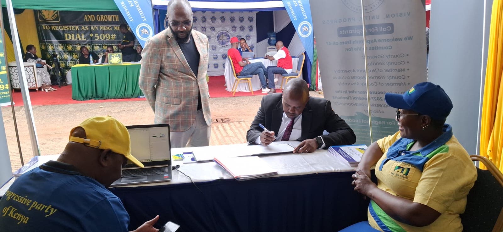 An aspirant signs his application at the PPOK registration desk